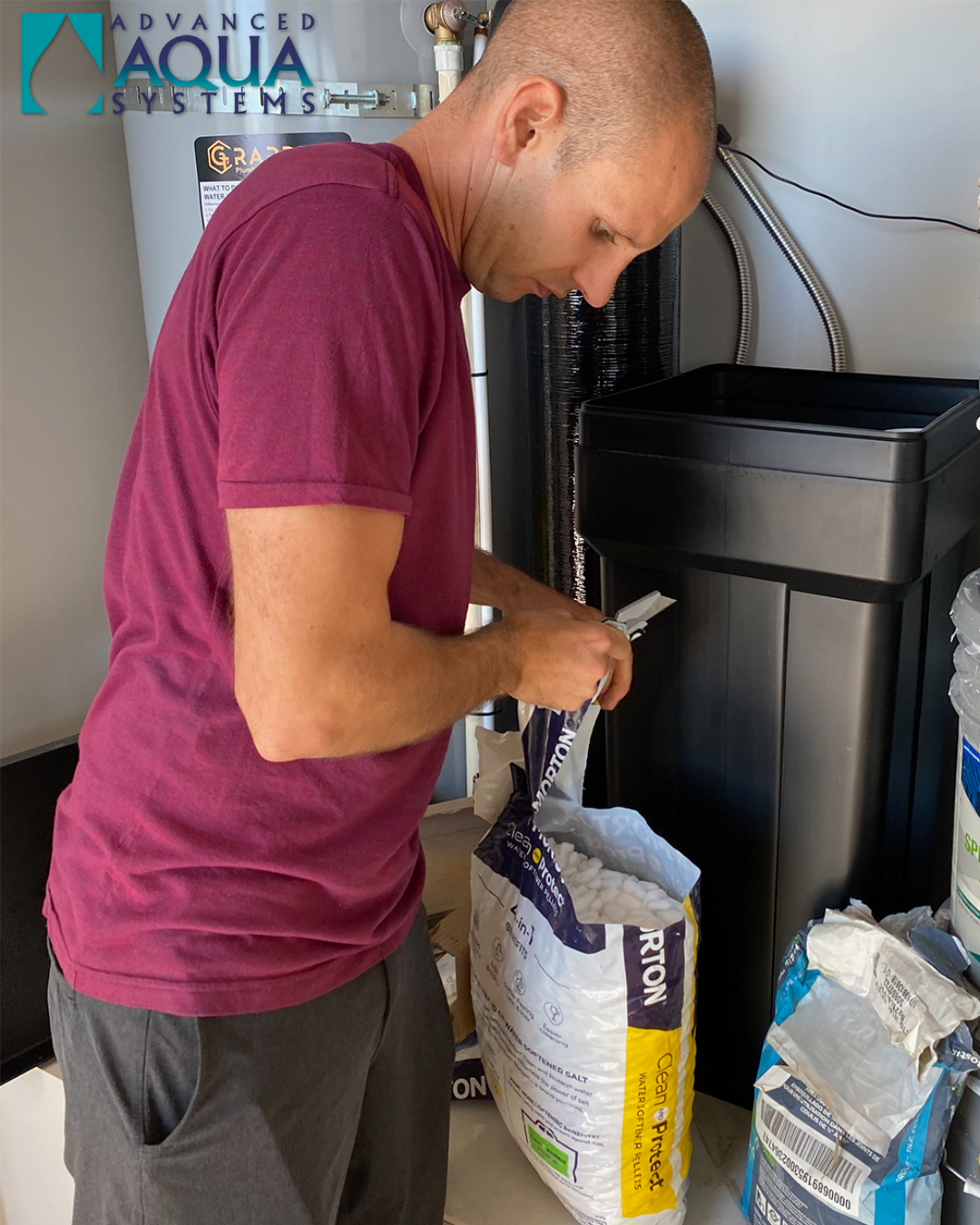 An Advanced Aqua Systems technician adds salt pellets to a soft water system in a home in St. George, Utah.